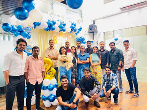 ImmensoTech software development company celebrating its 8th anniversary milestone with the agency team